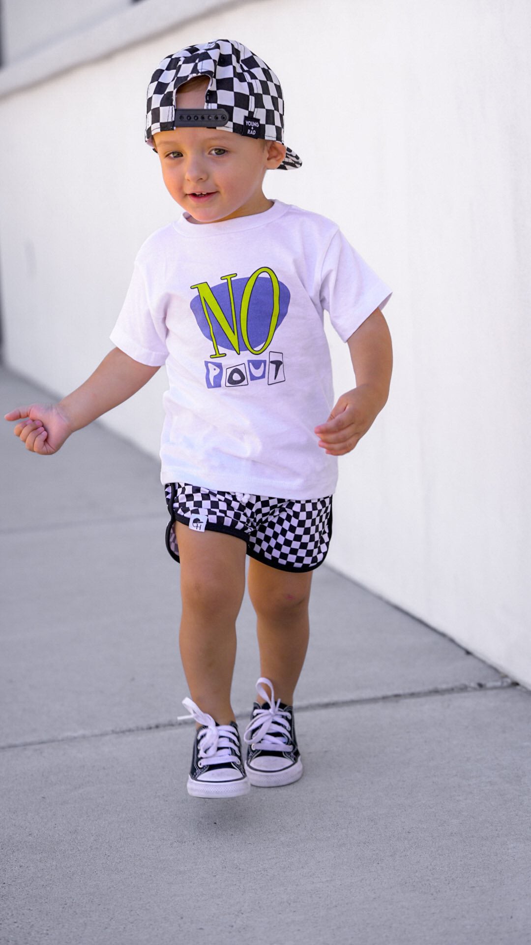 two year old wearing no pout toddler tee