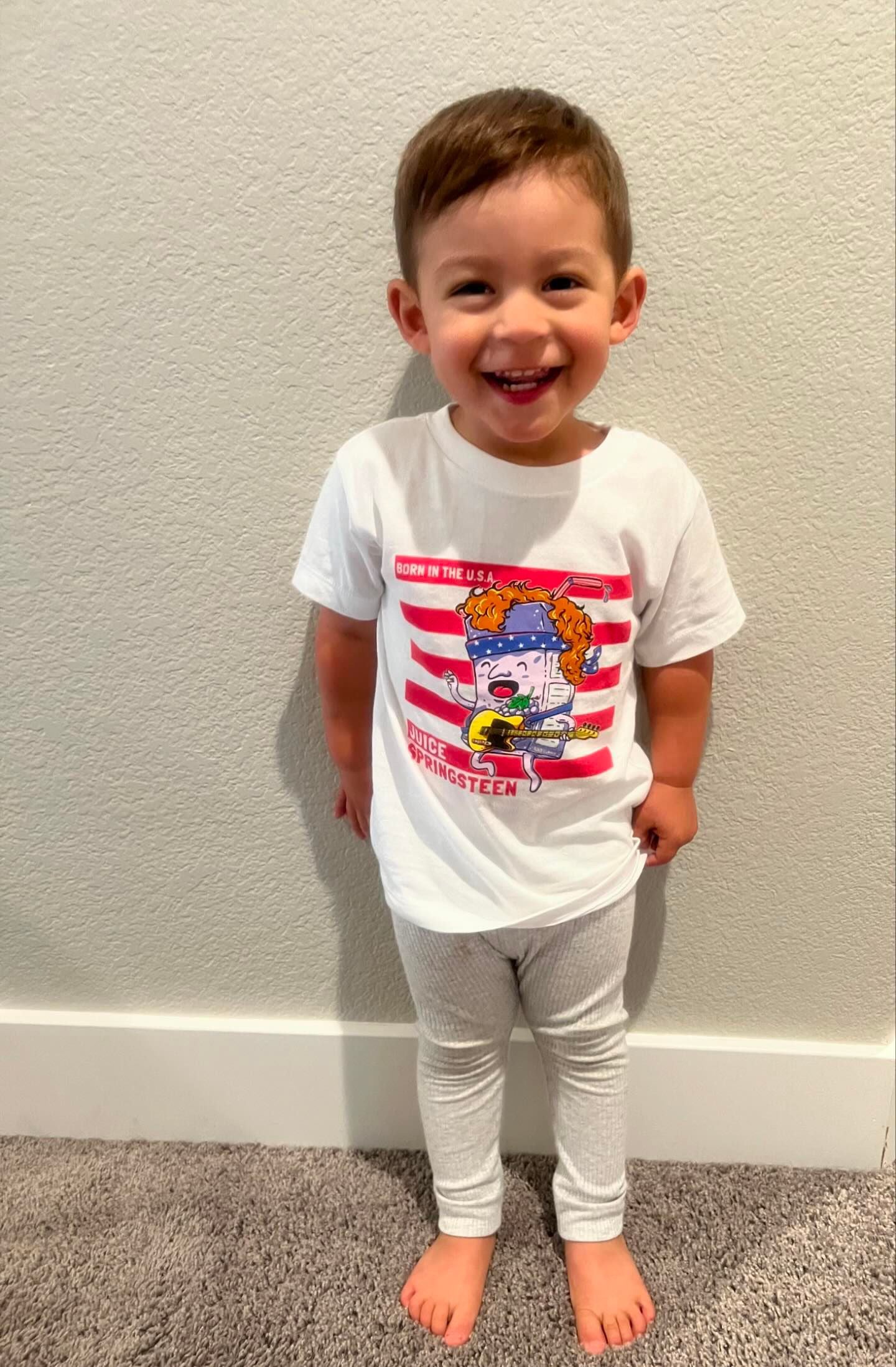 toddler wearing a juice springsteen pun tshirt