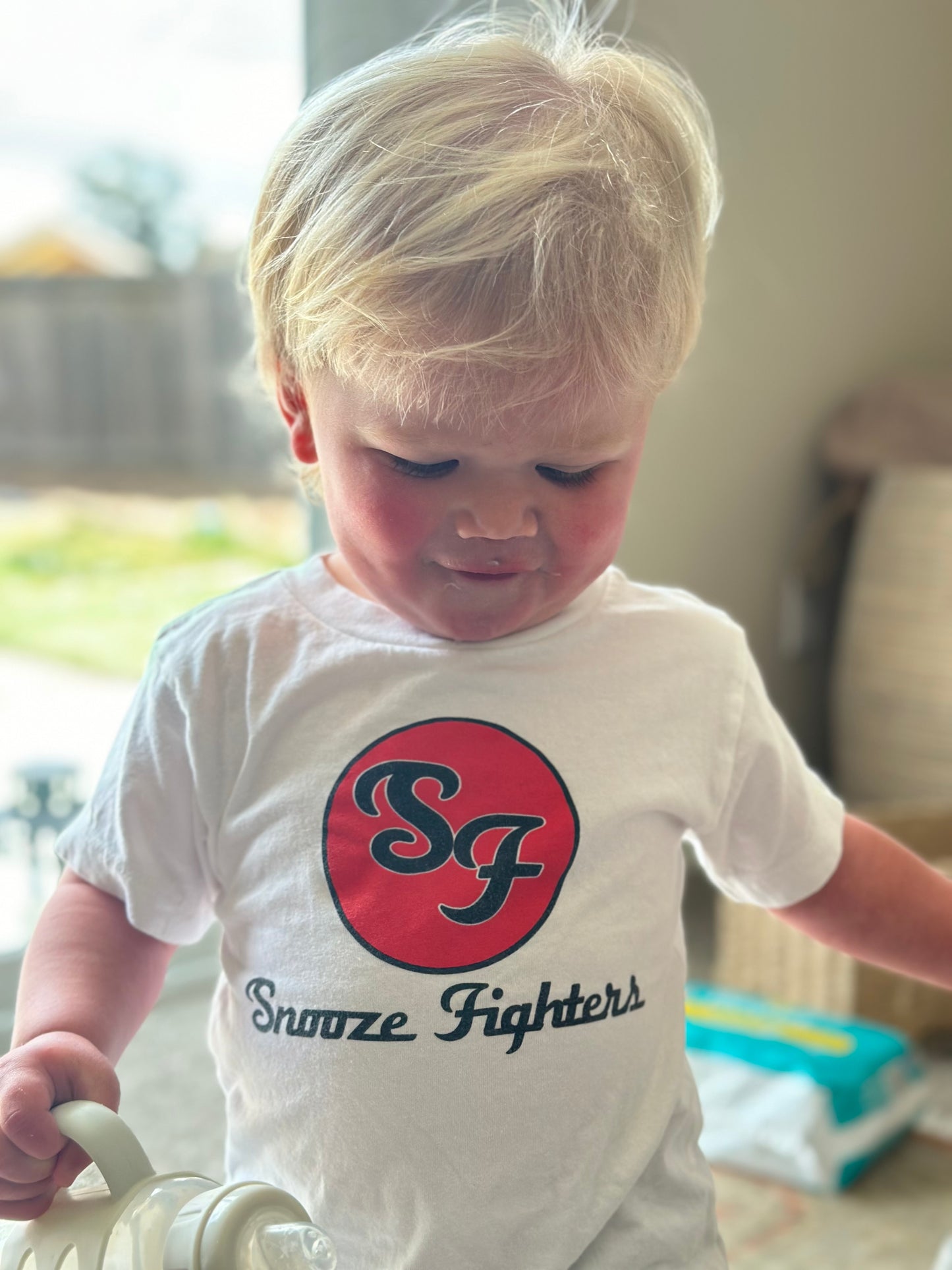 baby wearing a snooze fighters pun tshirt