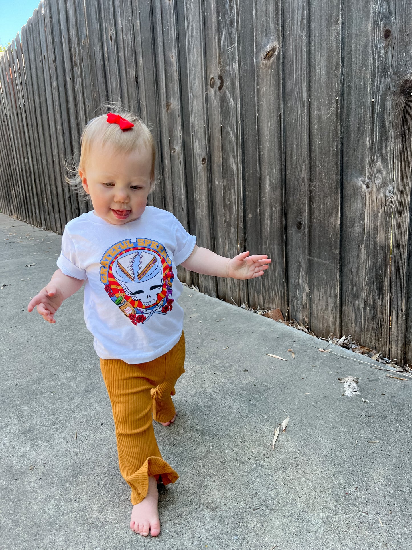 baby wearing grateful spread rock band tee